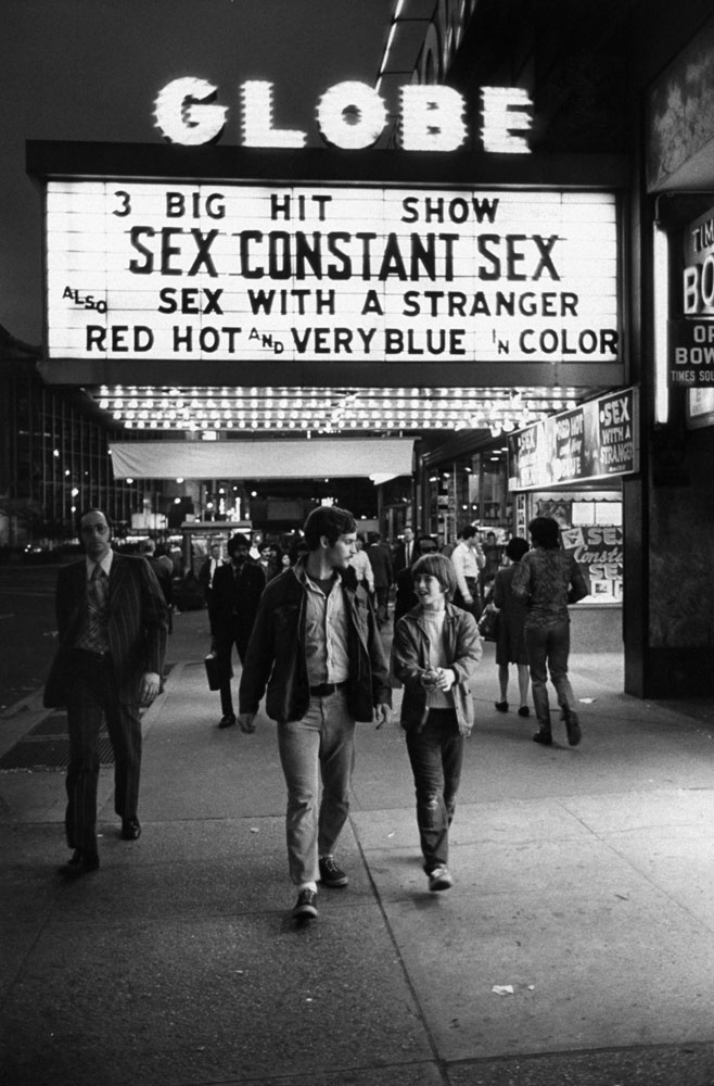 A father and son walk past the Globe Theater in 1971.