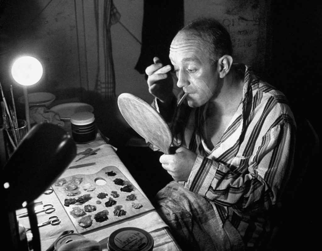 Alec Guinness puts on his make-up during a run at at the Stratford Shakespeare festival in 1958.