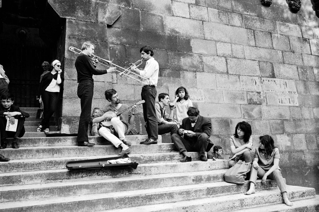 Young Parisians enjoy an impromptu outdoor concert on the banks of the Seine, 1963.