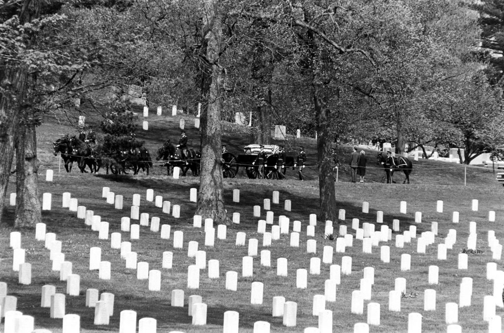 Horses pull a caisson through Arlington National Cemetery, 1965.