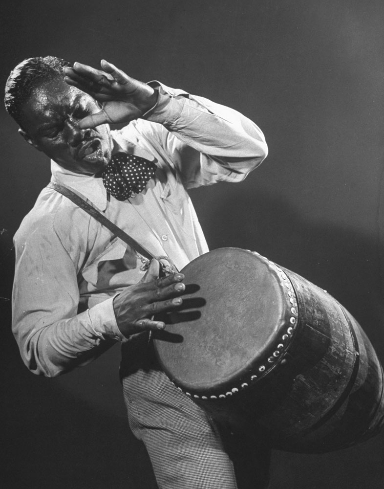 Frenzied Drummer named Gonzales (but called Chano Pozo) whips beboppers into fever with Congo beat. Dizzy rates him world's best drummer.