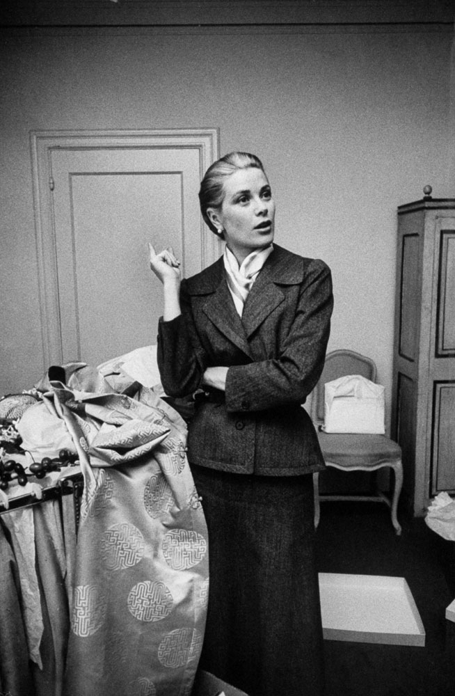 Grace Kelly takes a momentary breather while packing her things before the wedding, 1956.