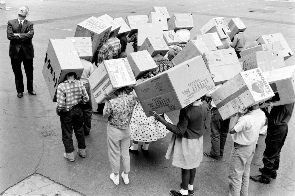 Children demonstrate how to watch a solar eclipse in 1963