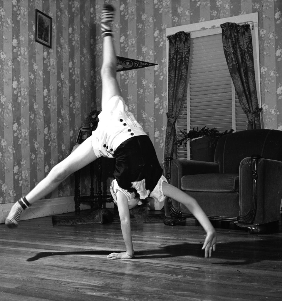 June Carter performing a cart wheel in the living room of her family's home.