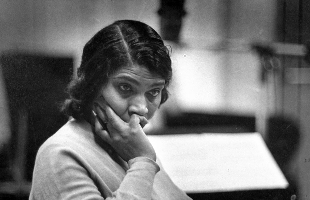 Marian Anderson listens doubtfully to her Brahams Alto Rhapsody. But orchestra applauded her.