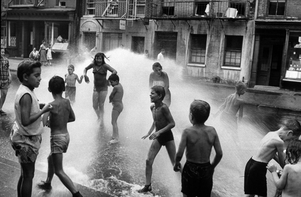 Children playing in water during a heat wave in New York City, 1953.