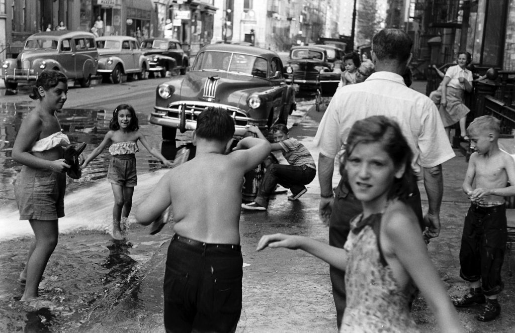 Children playing in water during a heat wave in New York City, 1953.