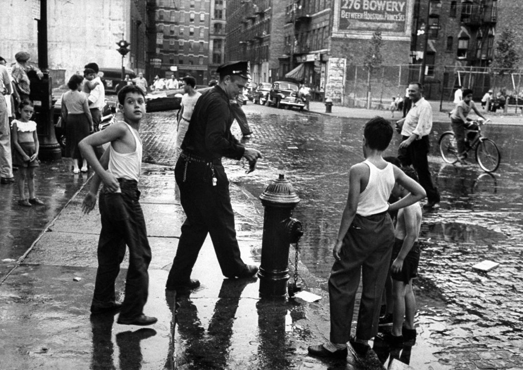 Children playing in water during a heat wave in New York City, 1953.