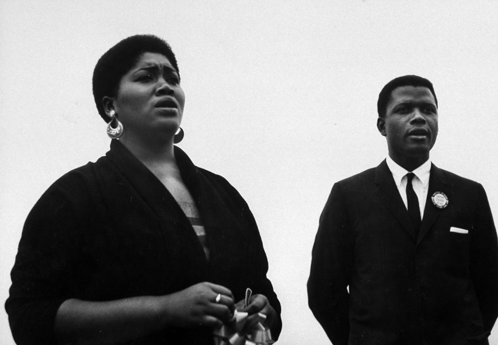 Folk singer Odetta at a civil rights rally at Statue of Liberty with Sidney Poitier, 1960.