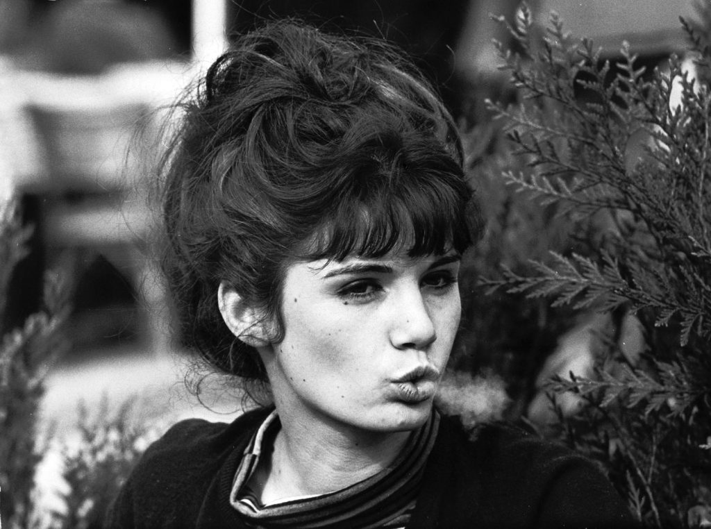 Young Parisian woman exhaling smoke, 1963.