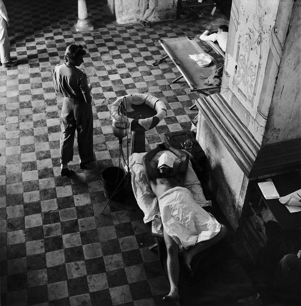 American Army nurse Florence Vehmeier and wounded GI in a makeshift hospital, Leyte, the Philippines, 1944. (Photo by W. Eugene Smith/The LIFE Picture Collection © Meredith Corporation)