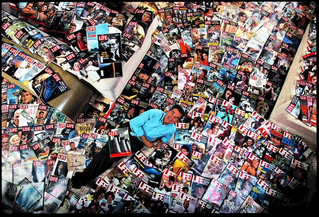 Dick Clark surrounded by his grandmother's complete collection of LIFE magazines, which he inherited on her death. On his lap is the 1936 premier issue.