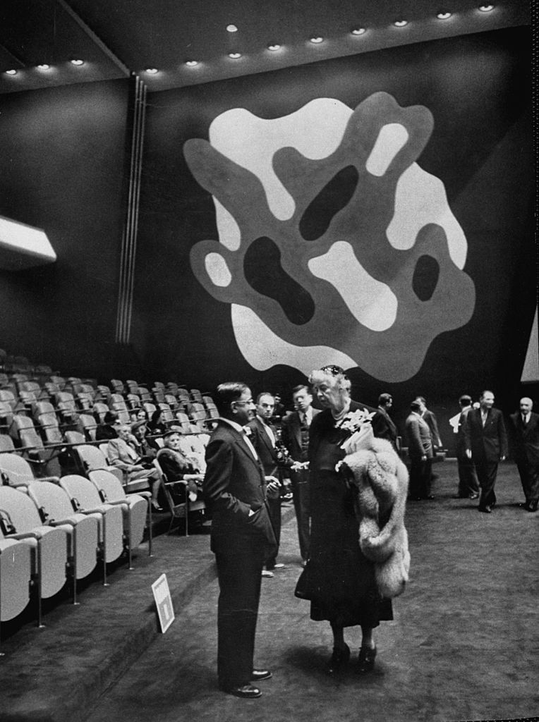 Eleanor Roosevelt talking to another UN delegate near a mural by artist Fernand Leger, 1952. (Photo by Lisa Larsen/The LIFE Picture Collection via © Meredith Corporation)