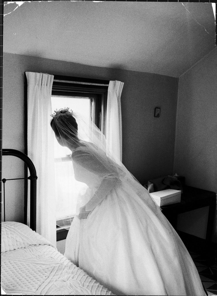 Bride prepares for wedding, in traditional white gown, 19th century wedding dress. (Photo by Michael Rougier/The LIFE Picture Collection © Meredith Corporation)