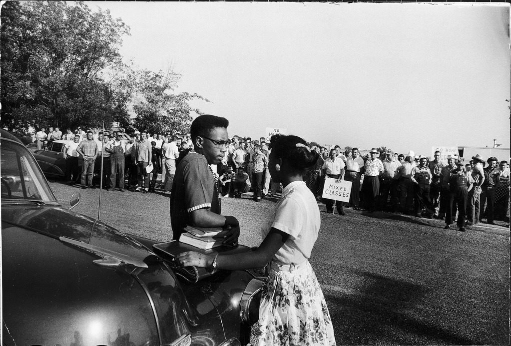 Students Steve Poster and Jessalyn Gray (fore C) talking at side of taxi while crowd of White Supremacists taunt them. (Photo by Joe Scherschel/The LIFE Picture Collection © Meredith Corporation)